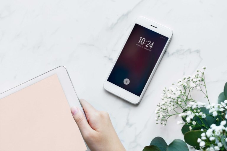 cell phone and ipad on marble table