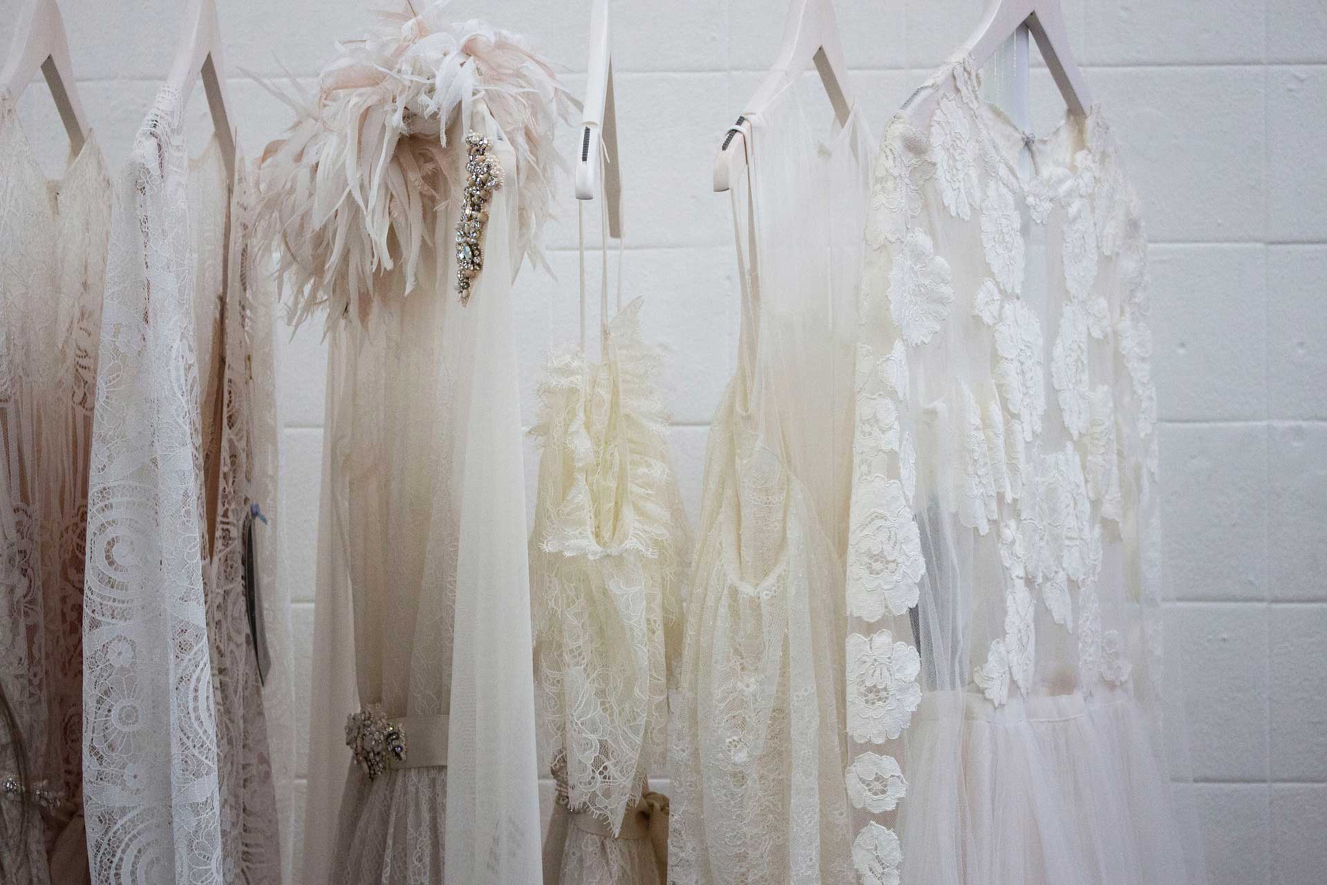 Pretty dresses hanging on a wardrobe rack