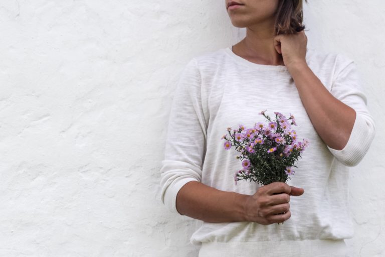 Woman holding flowers, searching for calling and purpose